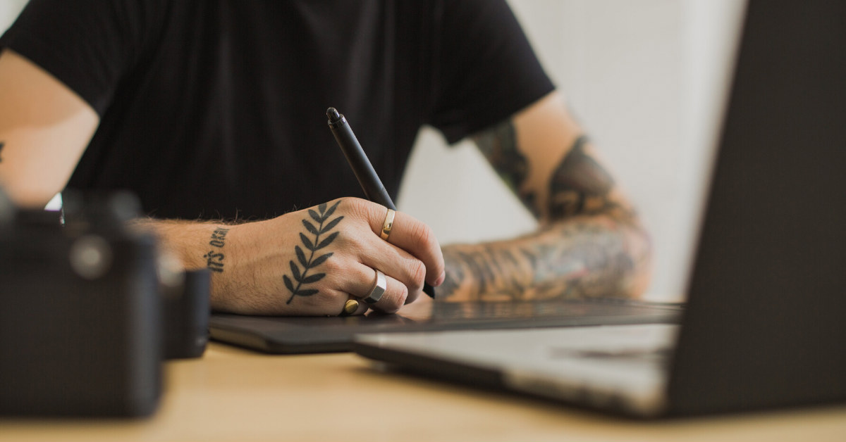 man holding sketch pen